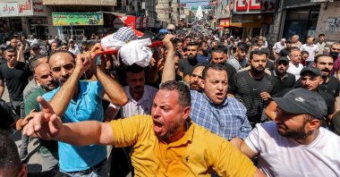 Mourners carry the body of Palestinian Bader al-Masri, who was killed while the Israeli army was securing "the coordinated entrance of Israeli civilians to Joseph's Tomb", during the funeral in the city of Nablus in the north of the occupied West Bank, Palestine, July 20, 2023. (AFP Photo)