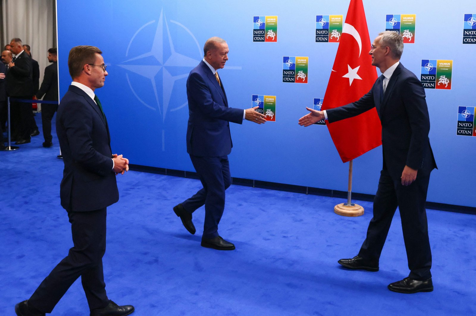 President Recep Tayyip Erdoğan (L) and NATO Secretary-General Jens Stoltenberg (R) shake hands next to Swedish Prime Minister Ulf Kristersson, in Vilnius, Lithuania, July 10, 2023. (AFP Photo)
