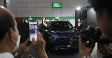 Visitors take photos of a Mercedes Benz EQB 250 electric vehicle (EV) car on display at the Fast Auto Show Thailand and EV Expo 2023 trade show at BITEC in Bangkok, Thailand, July 5, 2023. (EPA Photo)