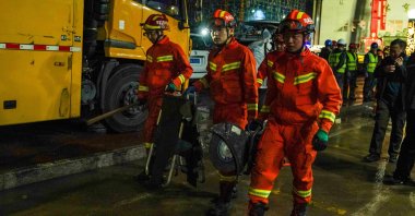 Firefighters transport equipment during a rescue operation at the site where the roof of a school gymnasium collapsed, in Qiqihar, Heilongjiang province, China, July 24, 2023. (Reuters Photo)