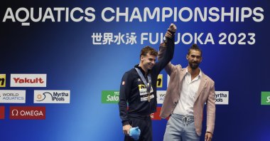 Michael Phelps (R) raises the hand of gold medalist Leon Marchand of France during the awarding ceremony of the Men's 400-meter Individual Medley final of the Swimming events during the World Aquatics Championships 2023, Fukuoka, Japan, July 23, 2023. (EPA Photo)