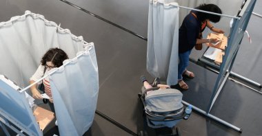 Voters mark their ballots inside polling booths at a polling station during the general election in Santiago de Compostela, Spain, July 23, 2023. (EPA photo)