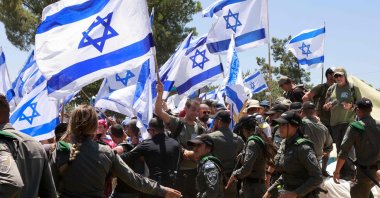 Protesters wave the Israeli flag during a demonstration near the Knesset in Jerusalem, July 24, 2023. (AFP Photo)