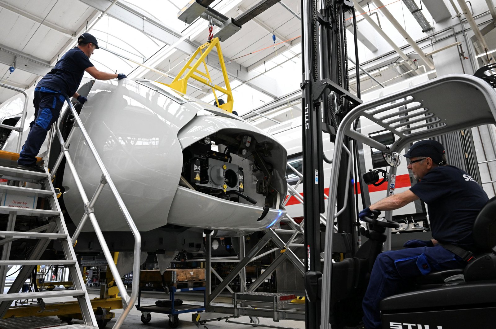 Workers install the nose section of Deutsche Bahn’s new high-speed train ICE 3 neo at the Siemens Mobility production plant in Krefeld, Germany, July 17, 2023. (Reuters Photo)