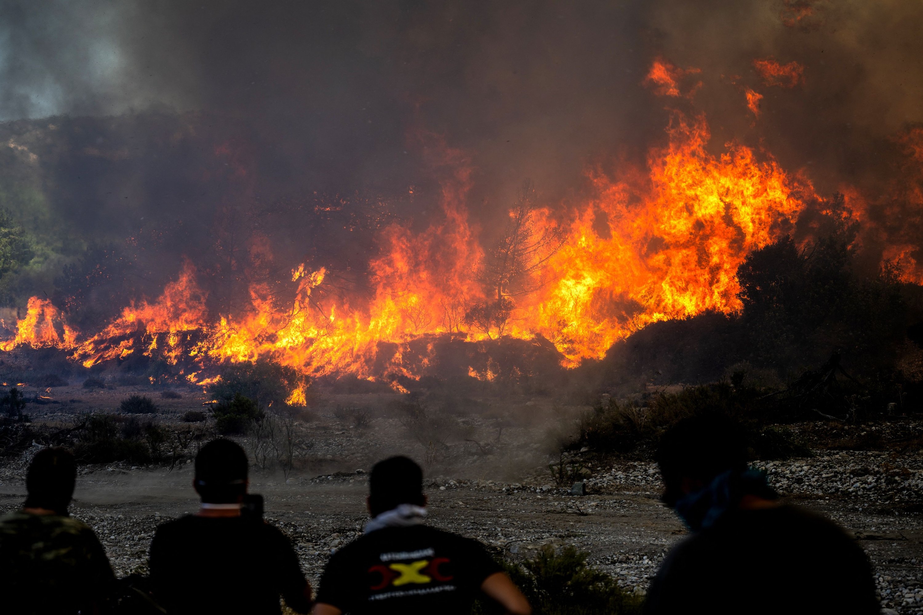 Locals watch the wildfires near the village of Vati, on the island of Rhodes, Greece, July 25, 2023. (AFP Photo)