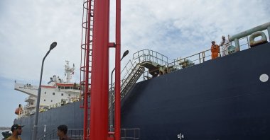 A security personnel stands next to a Russian cargo ship carrying crude oil at the Karachi port in Karachi, Pakistan, June 28, 2023. (AFP Photo)