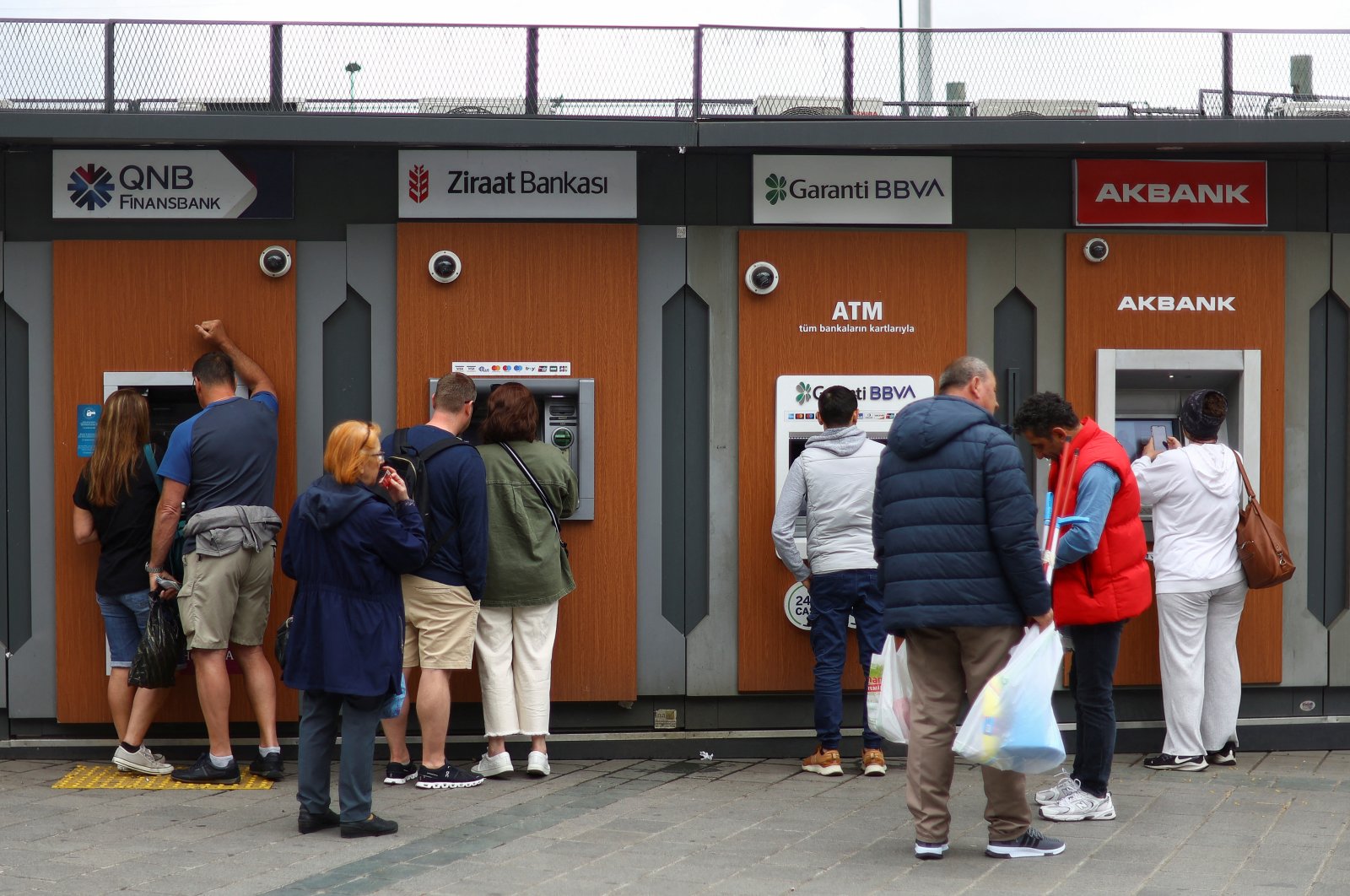 People use ATMs in Istanbul, Türkiye, May 29, 2023. (Reuters Photo)