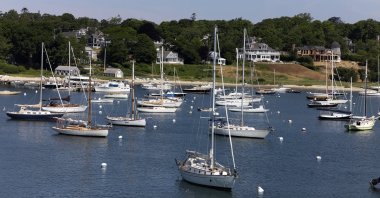 Sailboats and motorboats are anchored in Vineyard Haven harbor, Sunday, June 28, 2020 in Tisbury, Mass. on the island of Martha's Vineyard. (AP Photo/Mark Lennihan)