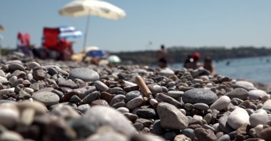 Cigarette buts seen strewn on the surface of Konyaaltı Beach, Antalya, Türkiye, July 26, 2023. (DHA Photo)