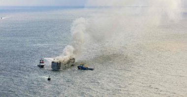This aerial photograph shows emergency boats extinguishing a fire aboard the Panamanian-registered car carrier cargo ship Fremantle Highway, off the coast of the northern Dutch island of Ameland. (AFP Photo)