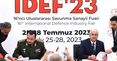 National Defense Minister Yaşar Güler (R) and Minister of Defense of Tajikistan General Şerali Mirzo (L) signs the agreement at IDEF, Istanbul, Türkiye, July 26, 2023. (AA Photo)