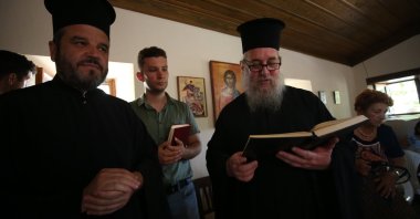 Kyrillos Sykis, the metropolitan of Gökçeada and Bozcaada (R), and members of the Greek Orthodox community celebrate Hagia Paraskevi Day at Ayazma Monastery, Bozcaada, northwestern, Türkiye, July 26, 2023. (AA Photo)