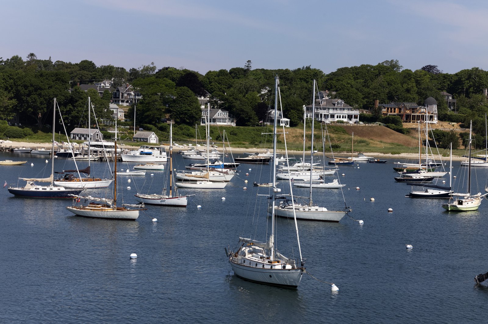 Sailboats and motorboats are anchored in Vineyard Haven harbor, Sunday, June 28, 2020 in Tisbury, Mass. on the island of Martha's Vineyard. (AP Photo/Mark Lennihan)
