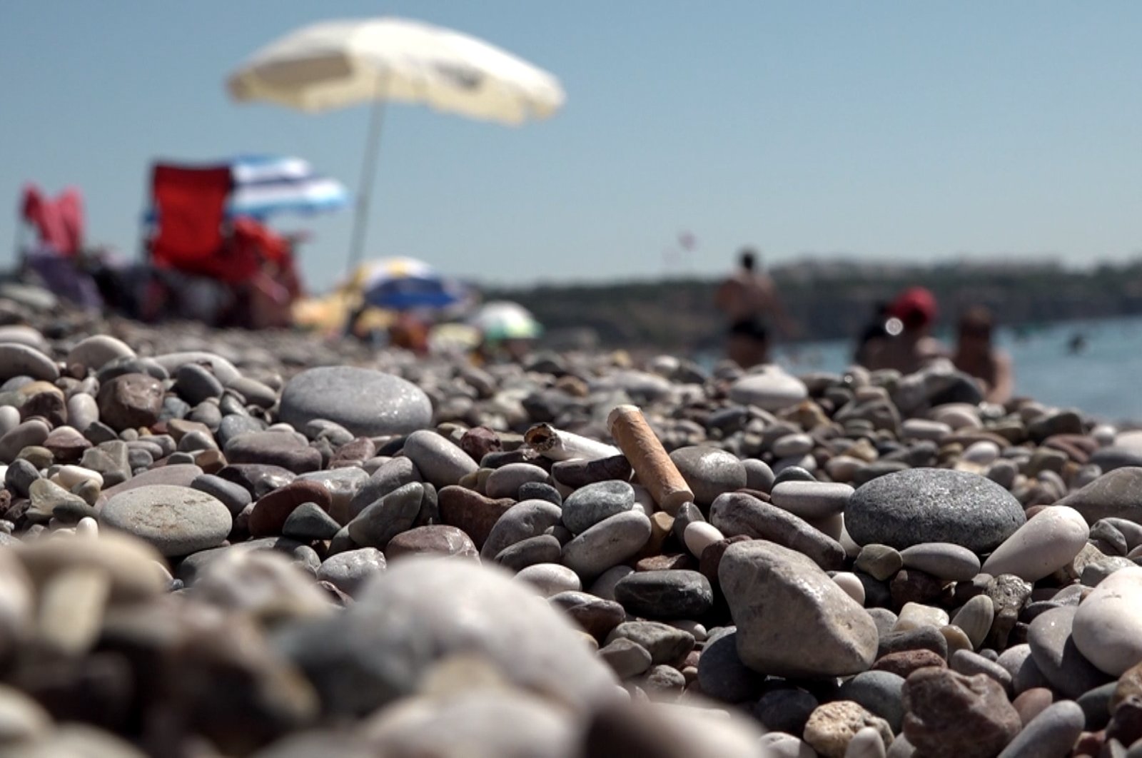 Cigarette buts seen strewn on the surface of Konyaaltı Beach, Antalya, Türkiye, July 26, 2023. (DHA Photo)