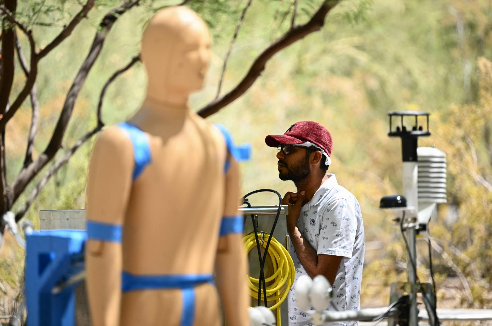 Ankit Joshi monitors a heat and wind experiment with robot ANDI, an Advanced Newton Dynamic Instrument, during a record heat wave in Phoenix, Arizona, U.S., July 20, 2023. (AFP Photo)