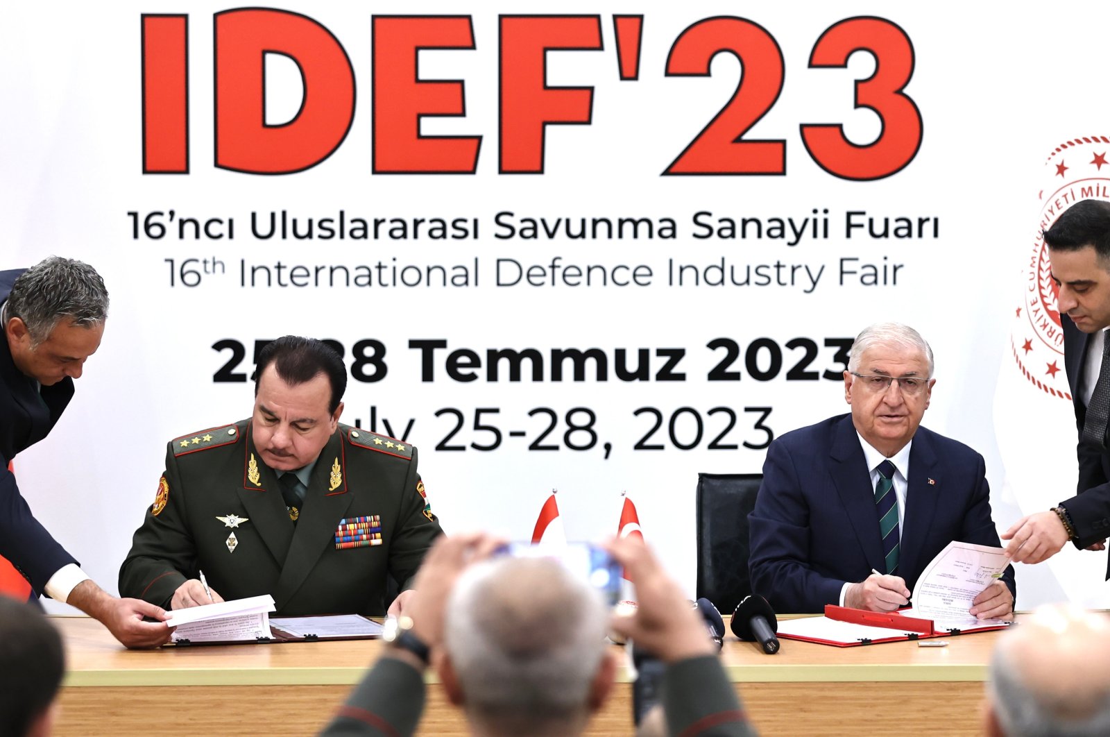 National Defense Minister Yaşar Güler (R) and Minister of Defense of Tajikistan General Şerali Mirzo (L) signs the agreement at IDEF, Istanbul, Türkiye, July 26, 2023. (AA Photo)