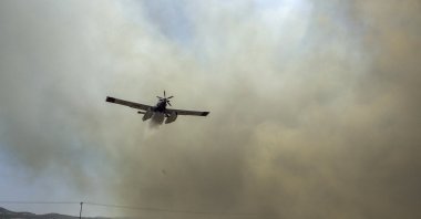 A firefighting aircraft drops water during a fire in Velestino, Magnesia prefecture, Greece, July 27, 2023. (EPA Photo)