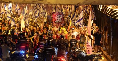 Demonstrators wave the Israeli flag during a march against the government&#039;s judicial reform plan in Tel Aviv, Israel, July 27, 2023. (AFP Photo)