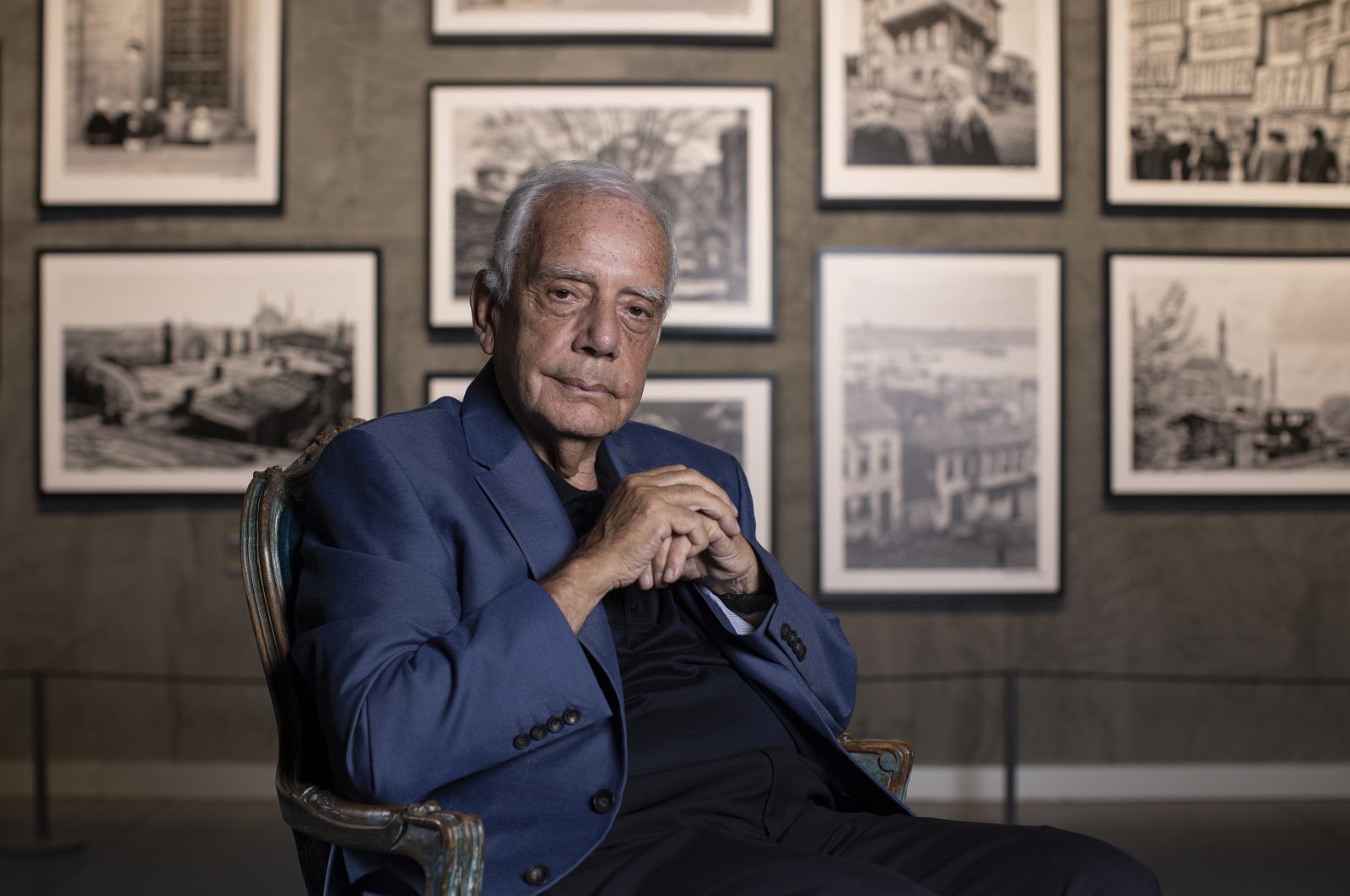 Hailed photographer Izzet Keribar poses with examples of his photography, Istanbul, Türkiye, July 7, 2023. (AA Photo)