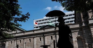 A pedestrian walks past the Bank of Japan building in central Tokyo, Japan, July 28, 2023. (AFP Photo)
