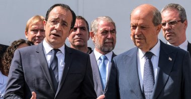 Greek Cypriot President Nikos Christodoulides (L) and Turkish Cypriot leader Ersin Tatar (R) speak to reporters outside the anthropological laboratory of the Committee on Missing Persons in Cyprus (CMP) in the United Nations buffer zone splitting the divided capital Lefkoşa (Nicosia), TRNC, July 28, 2023. (AFP Photo)