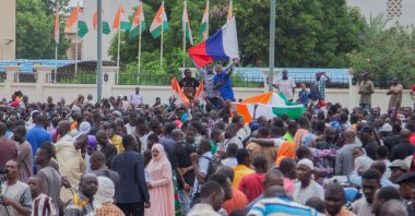 Hundreds of coup supporters gather and hold a Russian flag in front of the National Assembly in the capital Niamey, Niger, July 27, 2023. (Reuters Photo)