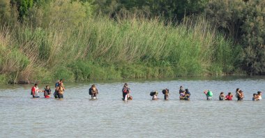 Migrants cross the Rio Grande from the Mexican side of the border toward the U.S. on July 16, 2023. (AFP Photo)