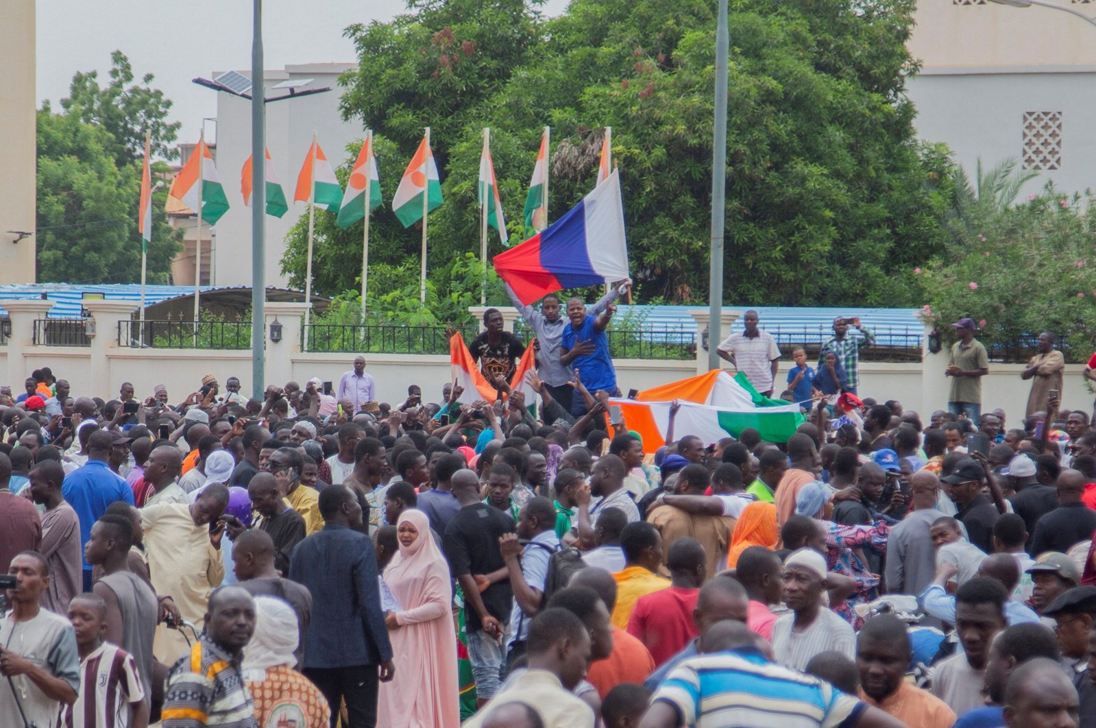 Hundreds of coup supporters gather and hold a Russian flag in front of the National Assembly in the capital Niamey, Niger, July 27, 2023. (Reuters Photo)