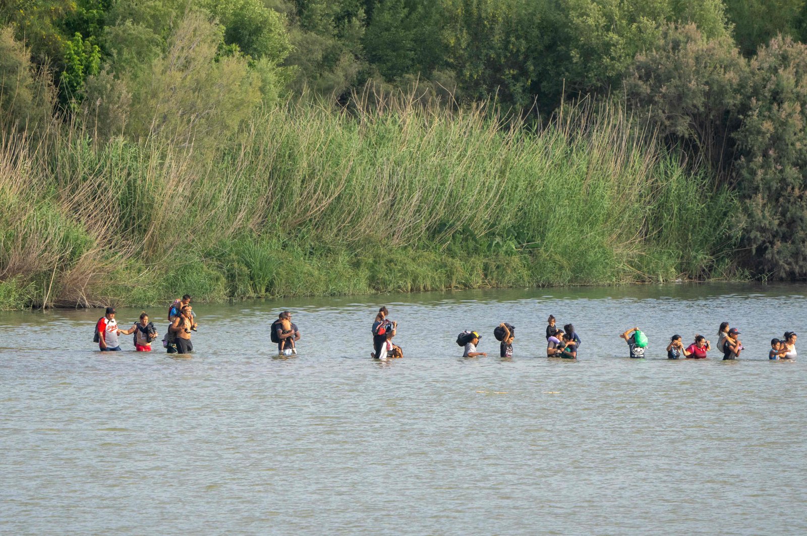 Migrants cross the Rio Grande from the Mexican side of the border toward the U.S. on July 16, 2023. (AFP Photo)