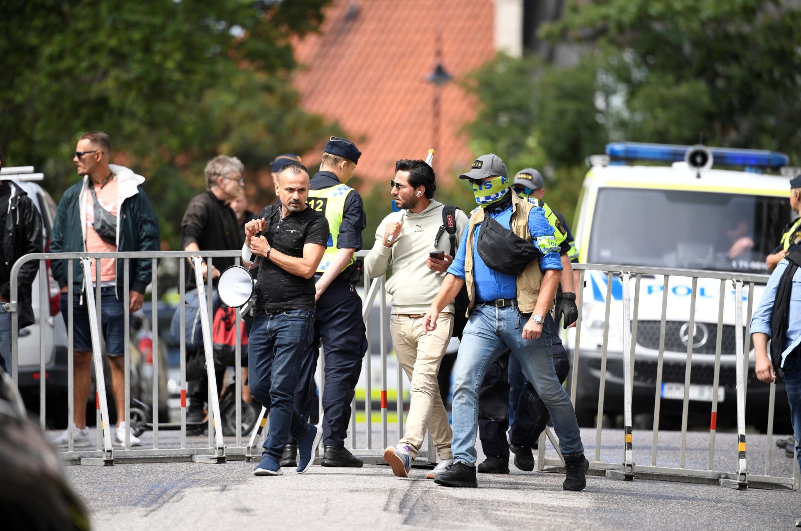 Iraqi refugee Salwan Momika, who planned to burn a copy of the Quran and the Iraqi flag,  is escorted by police to a location outside the Iraqi embassy, in Stockholm, Sweden July 20, 2023. (TT News Agency via Reuters, File Photo)
