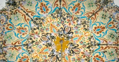 A close-up view of the details of a colorful floral pattern on the ceiling of the tomb of Attar of Nishapur, a renowned Iranian poet from the medieval era and theoretician of Sufism, Nishapur, Iran, Aug. 19, 2014. (Getty Images Photo)