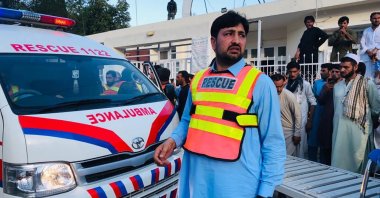 A rescuer waits in front of an ambulance following a blast at a political gathering in Bajaur, Pakistan, July 30, 2023. (EPA Photo)
