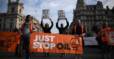 Just Stop Oil climate activists march slowly in Parliament Square in London, Britain, July 21, 2023. (AFP Photo)