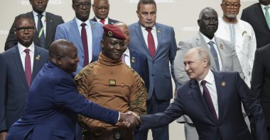 Russian President Vladimir Putin (R) and Mozambique President Filipe Nyusi shake hands during a family photo opportunity during the Russia Africa Summit in St. Petersburg, Russia, July 28, 2023. (AP Photo)