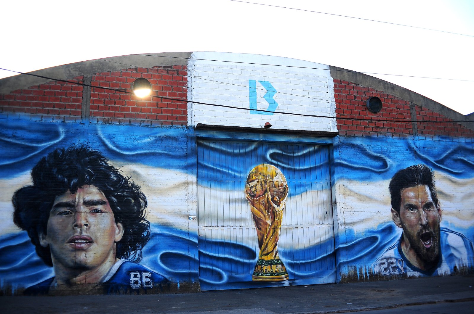 A mural of the late Diego Armando Maradona next to Lionel Messi is seen in Adrogue, Buenos Aires, Argentina, July 19, 2023. (Getty Images Photo)