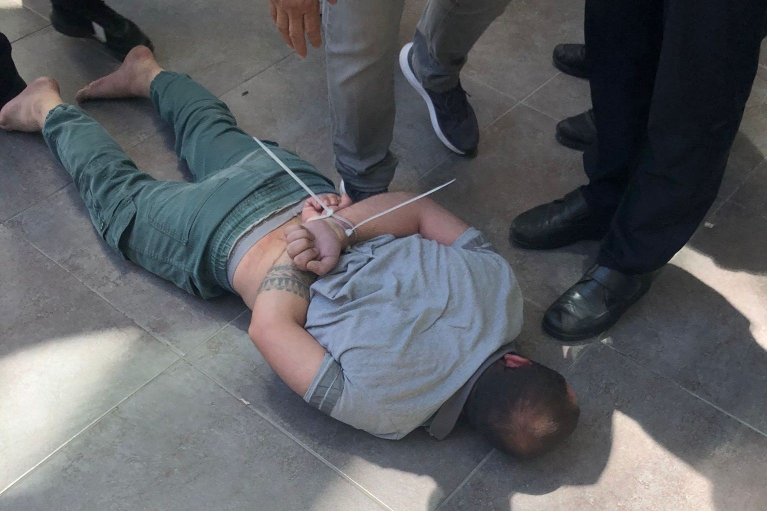 Gunman is detained by security forces following an attack at Swedish Consulate in Izmir, Aug. 1, 2023. (IHA Photo)