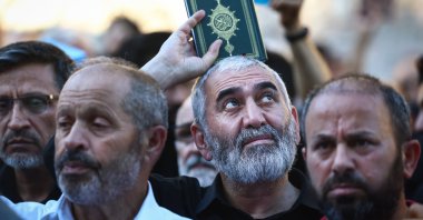 A protester holds a copy of the Quran as they attend a protest against Sweden for allowing anti-Muslim right-wing extremists to desecrate and burn copies of the Muslim holy book in Stockholm and Copenhagen, in front of the Consulate General of Sweden in Istanbul, Türkiye, July 30, 2023. (EPA Photo)