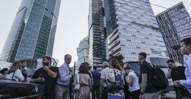 People walk near a damaged building in the Moskva-City business center following a reported drone attack in Moscow, Russia, August 1, 2023. (EPA Photo)