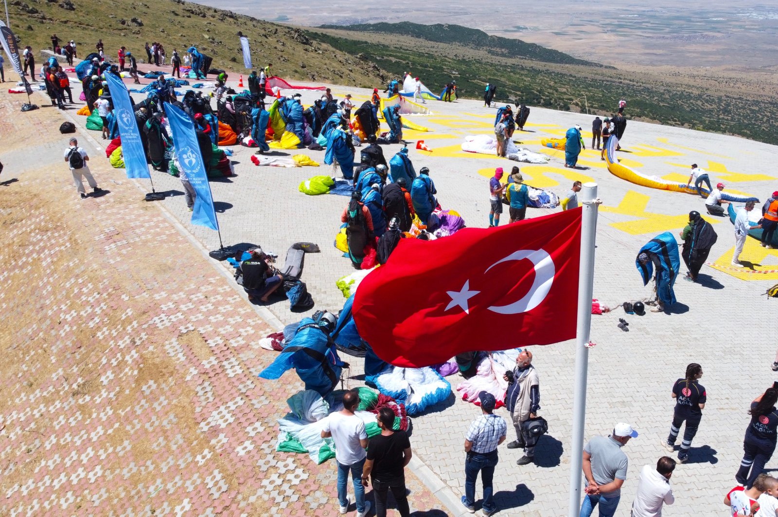 Pilots and medics stand ahead of the commencement of the Paragliding World Cup, Aksaray, Türkiye, July 30, 2023. (AA Photo)