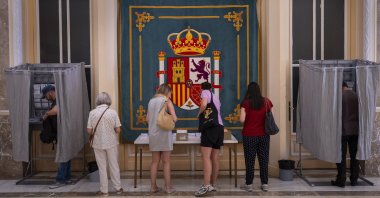 People pick their ballots before voting at a polling station for Spain&#039;s general election, in Madrid, Spain, July 23, 2023. (AP Photo)