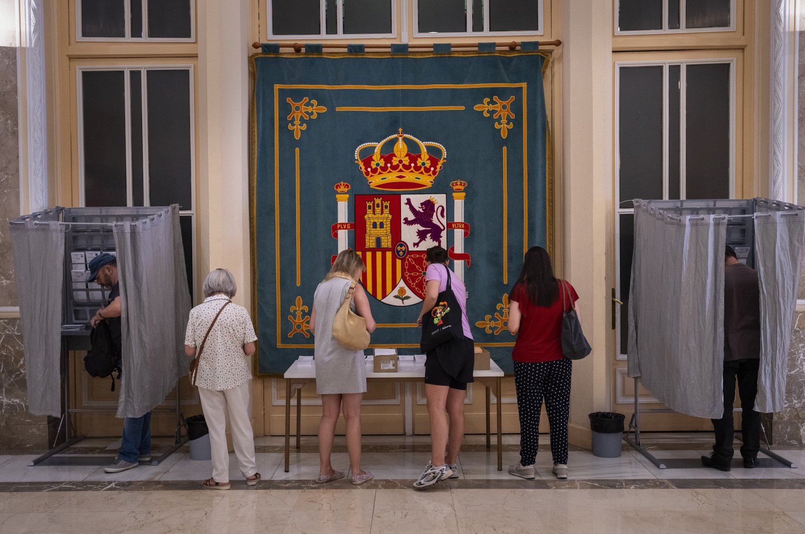 People pick their ballots before voting at a polling station for Spain&#039;s general election, in Madrid, Spain, July 23, 2023. (AP Photo)