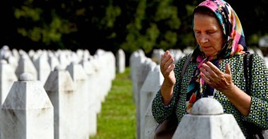 A Bosnian Muslim woman and survivor of the 1995 Srebrenica genocide mourns near the graves of relatives and victims, Srebrenica, Bosnia and Herzegovina, July 11, 2023. (AFP Photo)