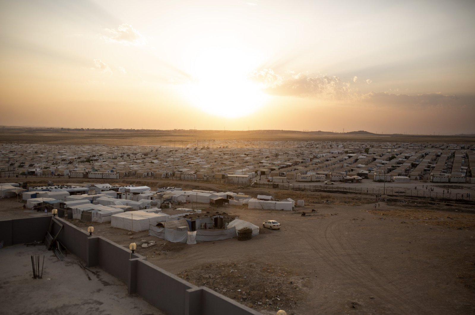 The sun sets over Sharia Camp, where Yazidis displaced by Daesh terrorists are housed near Dohuk, Iraq, Aug. 24, 2019. (AP File Photo)