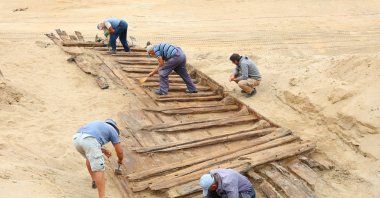 Archaeologists excavate the hull of a wooden ship, an ancient Roman flat-hulled riverine vessel at the ancient city of Viminacium, near Kostolac, Serbia, Aug. 2, 2023. (Reuters Photo)