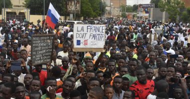 Protesters hold an anti-France placard during a demonstration on independence day in Niamey. Niger, Aug. 3, 2023. (AFP Photo)