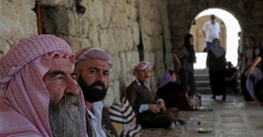 Iraqi Yazidis sit at the Temple of Lalish in a valley near Dohuk, Northern Iraq, Aug. 2, 2023. (AFP Photo)