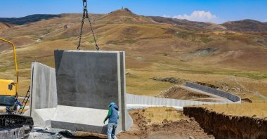 Workers install concrete blocks on the border wall, in Van, eastern Türkiye, July 17, 2023. (AA Photo) 