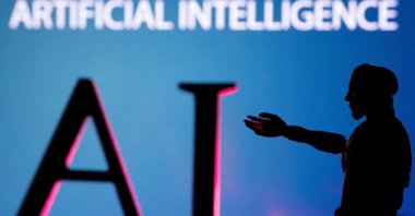 Artificial intelligence letters and robot miniature are seen in this illustration photo, June 23, 2023. (Reuters Photo)