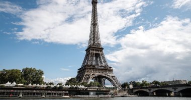 The Eiffel Tower next to the Seine River as it passes through Paris, France, Aug. 04, 2023.
