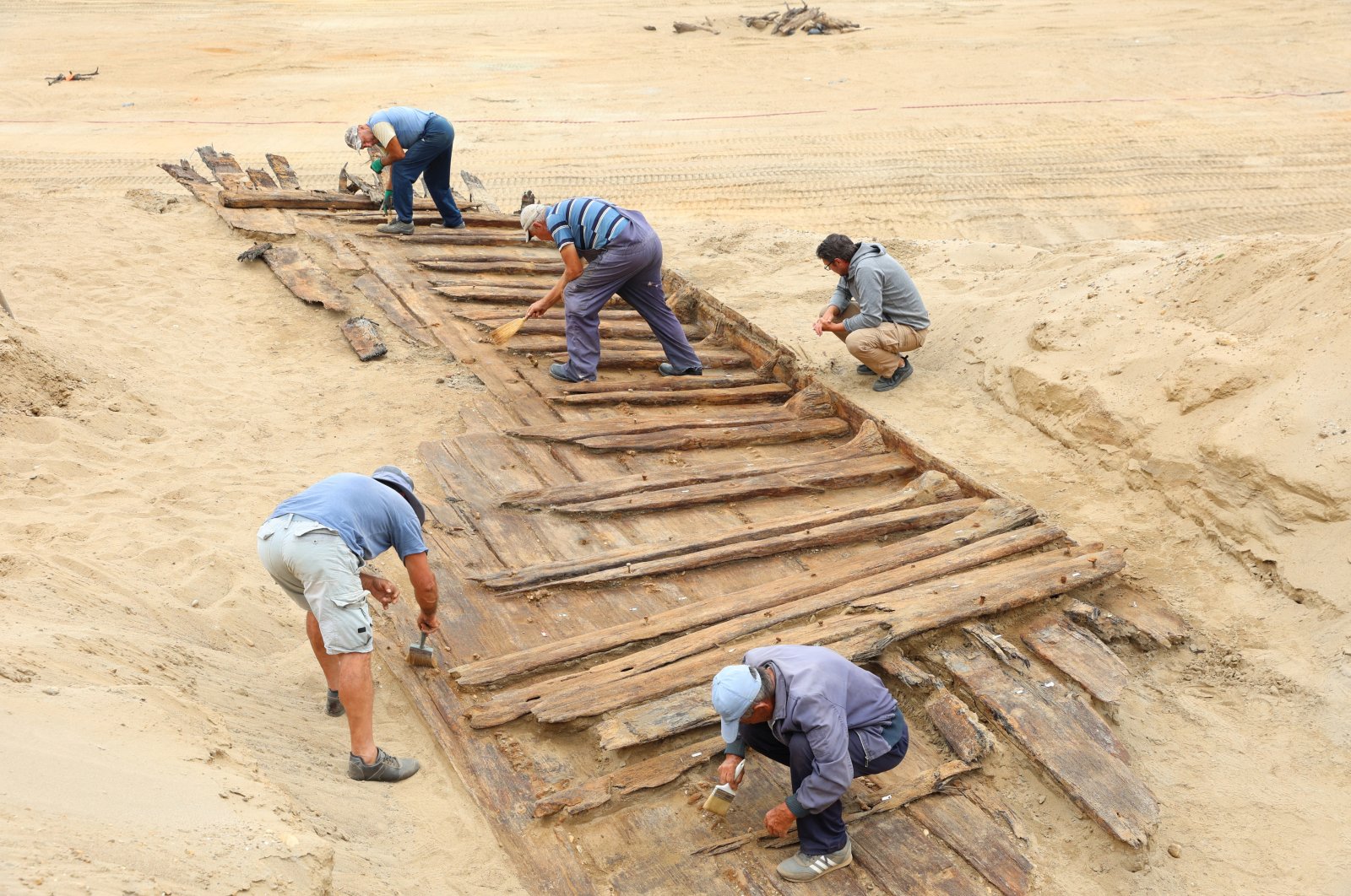 Archaeologists excavate the hull of a wooden ship, an ancient Roman flat-hulled riverine vessel at the ancient city of Viminacium, near Kostolac, Serbia, Aug. 2, 2023. (Reuters Photo)